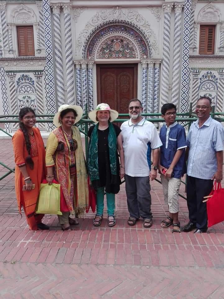 BLCC students and teacher posing in front of an ornately decorated building