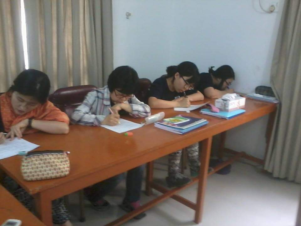 BLCC students focused on a Bangla writing exercise in class