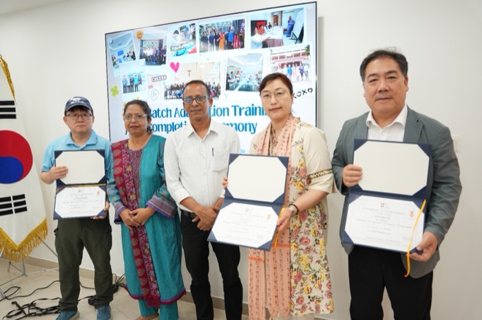 BLCC students and teacher holding their certificates at a Bangla language course completion ceremony