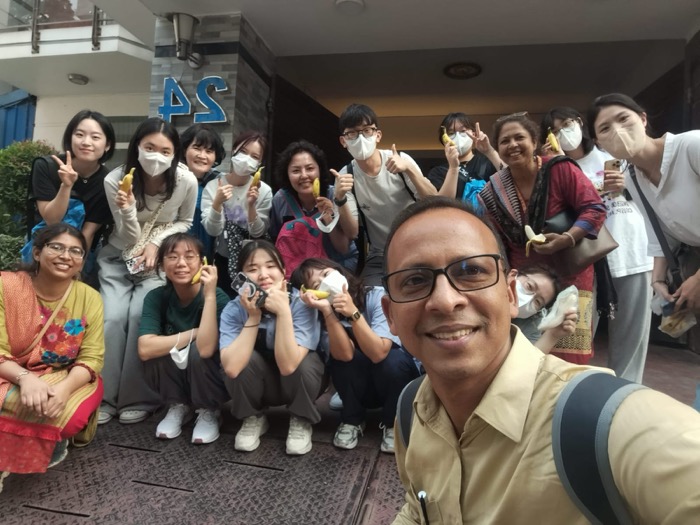 A large group of BLCC students and staff posing together outside after class