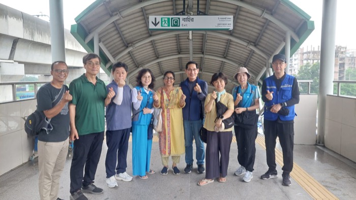 BLCC students and teacher posing together at a Dhaka metro station during an outing