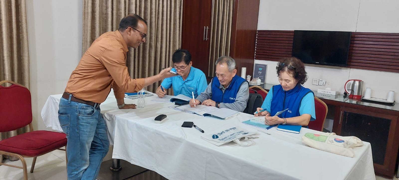 BLCC instructor Pallab helping KOICA volunteer students with their Bangla coursework