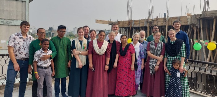 A group of BLCC students and staff posing on a Dhaka rooftop