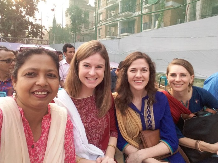 BLCC students and friends smiling on a rooftop overlooking Dhaka