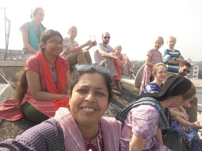 BLCC students sightseeing with their teacher at a decorated building in Dhaka