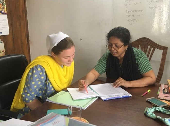 A BLCC student learning Bangla one on one with her teacher