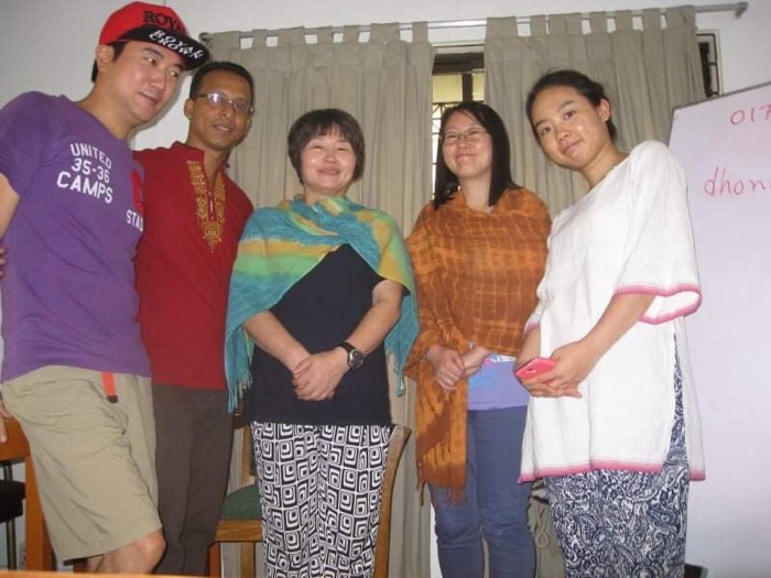 A group of BLCC students posing together after class in traditional Bangladeshi dress